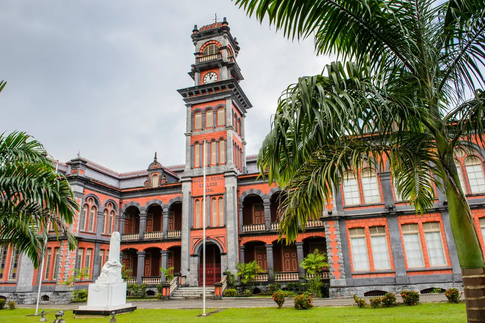 Queen's Royal College in Port of Spain with green palm trees in the foreground to indicate the best time to visit Trinidad