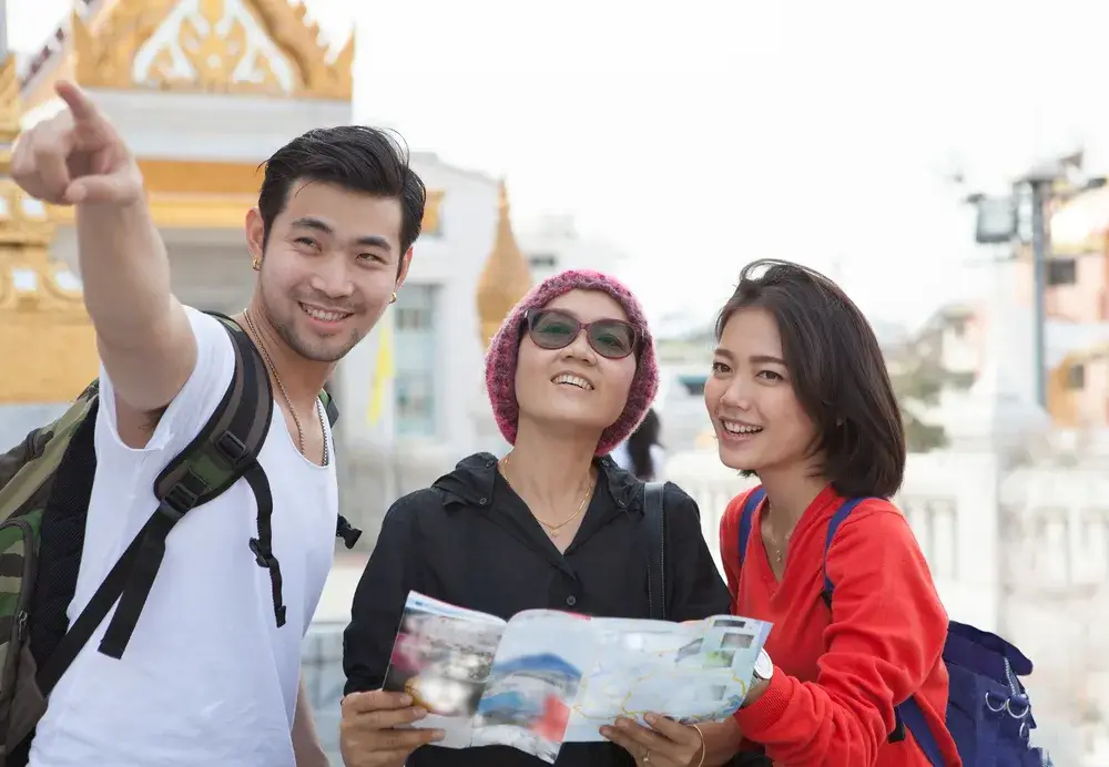 For a guide titled Is Thailand Safe to Visit, a tour guide pointing to something in the distance