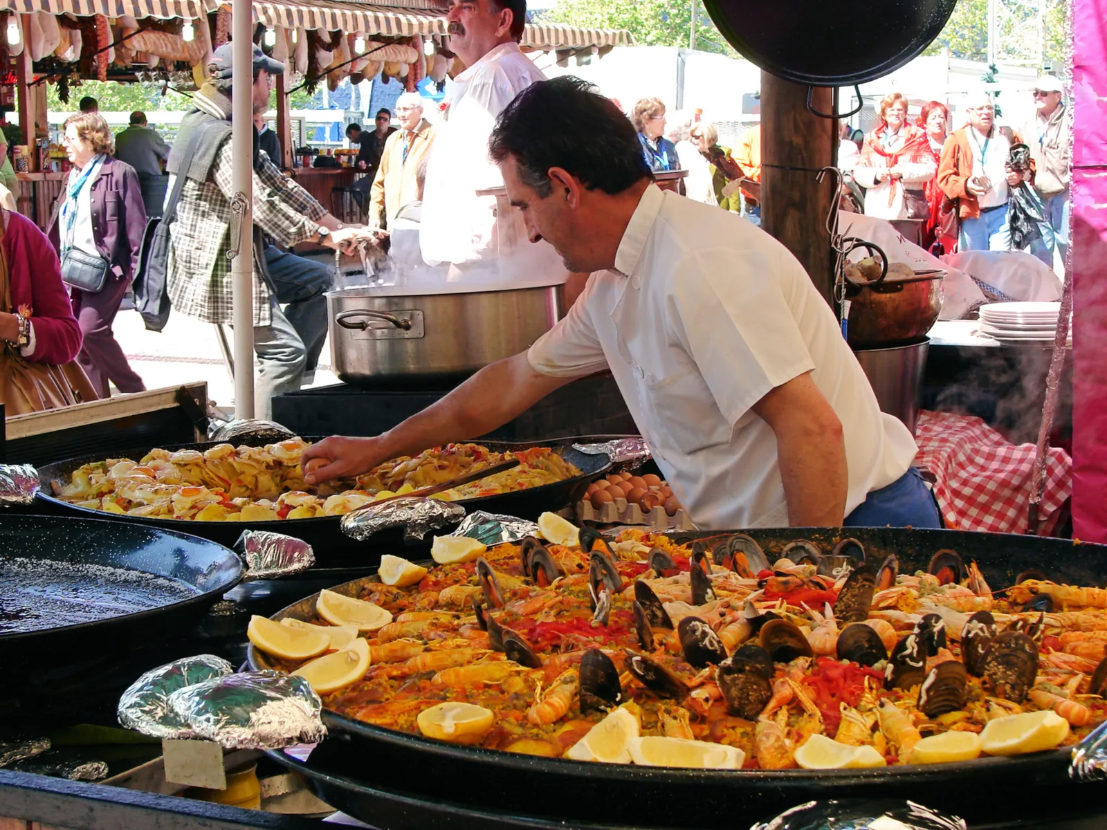 Flavorful cuisine made by a man in a street food cart for a piece on the best time to visit Barcelona