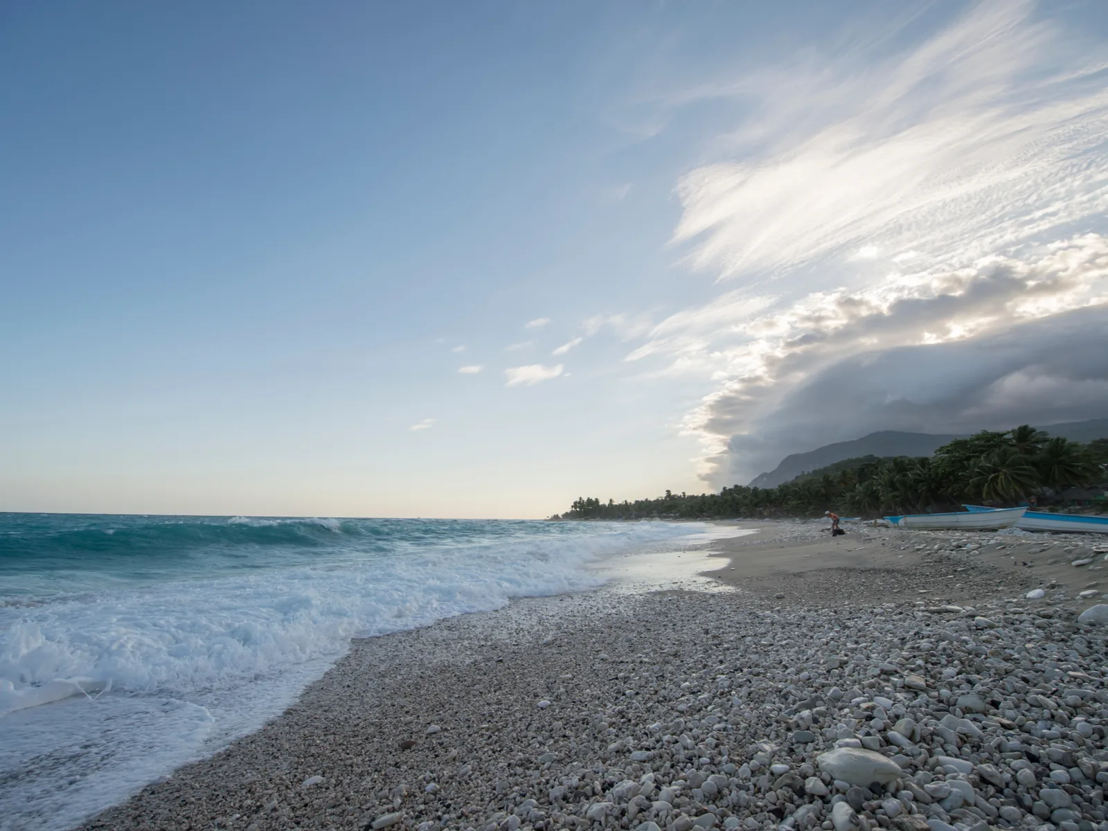 A pebbly foamy shore of Playa Bahoruco in Barahona, one of the best beaches in the Dominican Republic