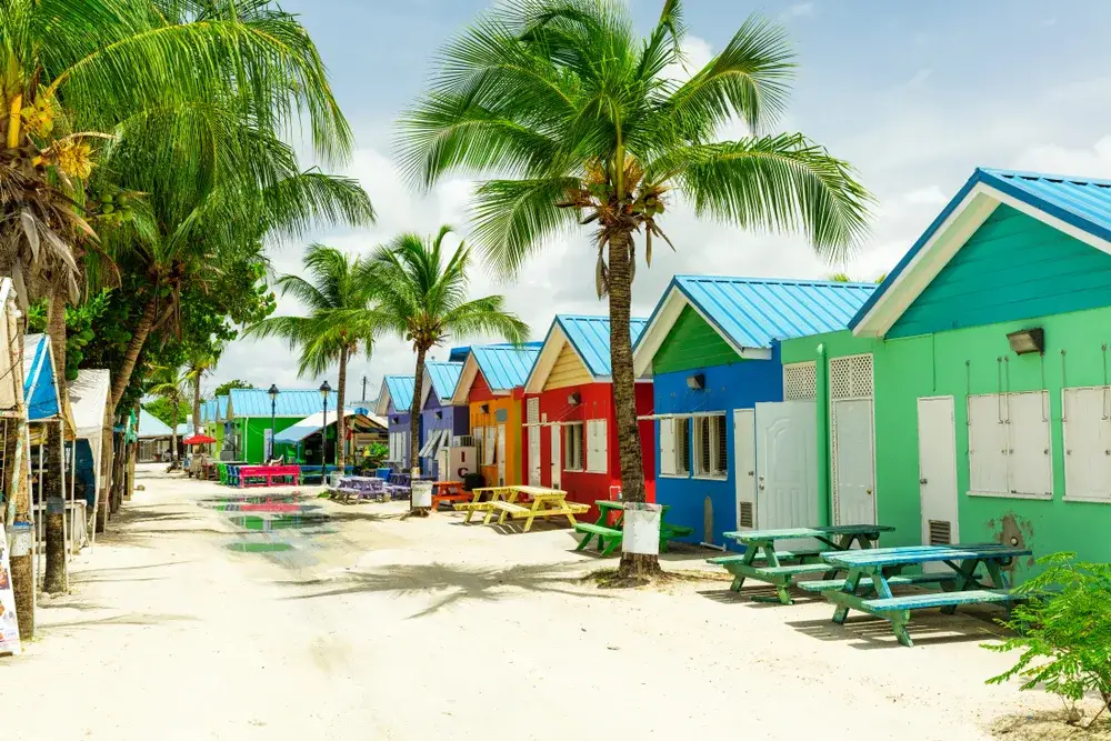 Colorful homes in Barbados pictured along a sandy beach