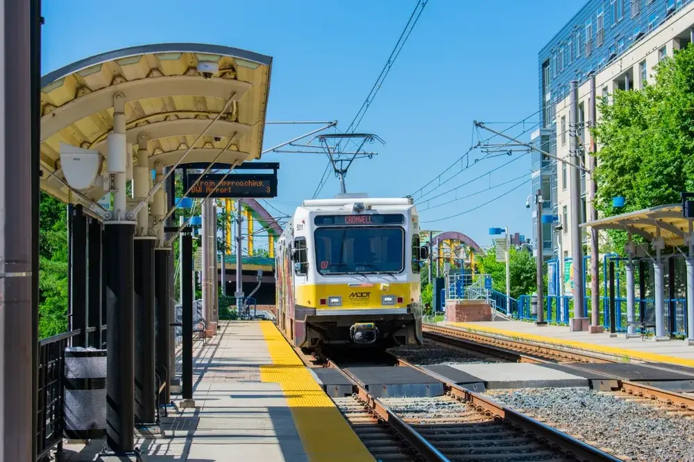 Light rail train approaches a station, as seen from the front, for a piece on Is Baltimore Safe