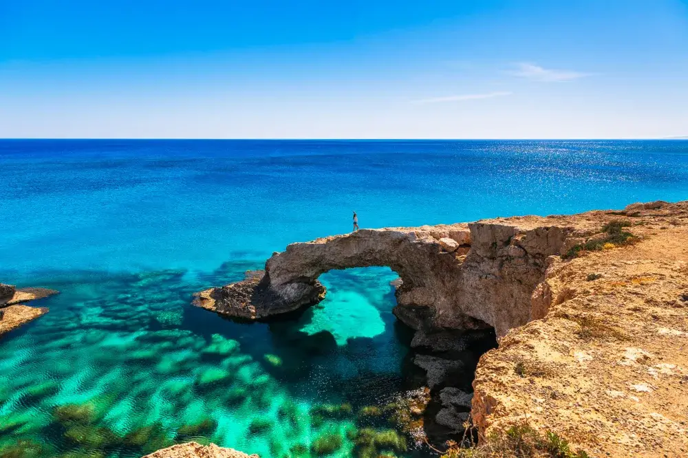 Woman on the big rock near Ayia for a guide to whether Cyprus is safe to visit