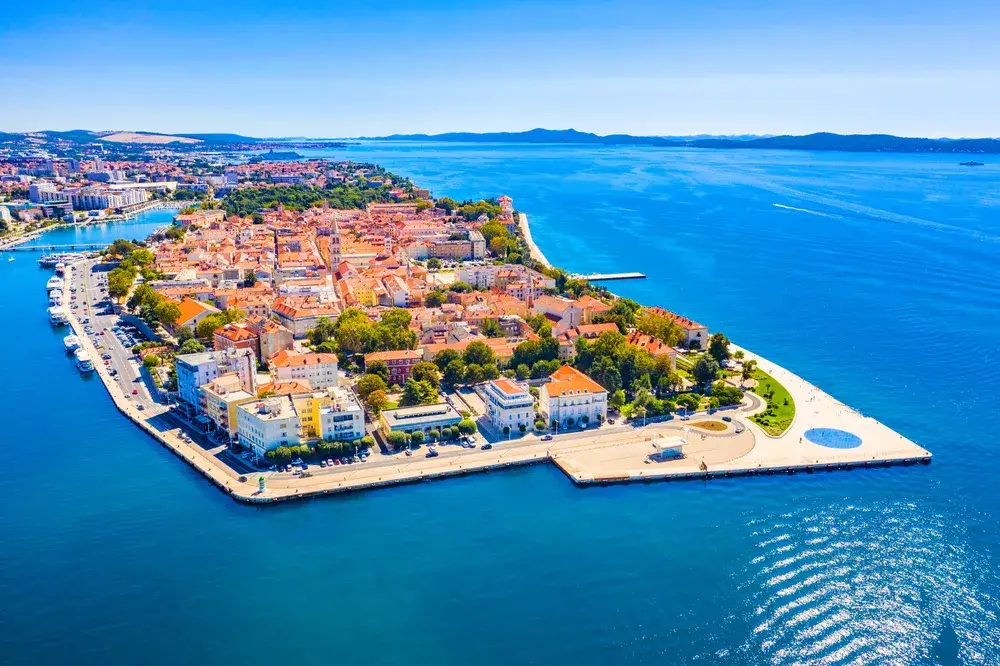 The old port city of Zadar, one of our picks for where to visit on a trip to Croatia, pictured from the air with deep blue water all around