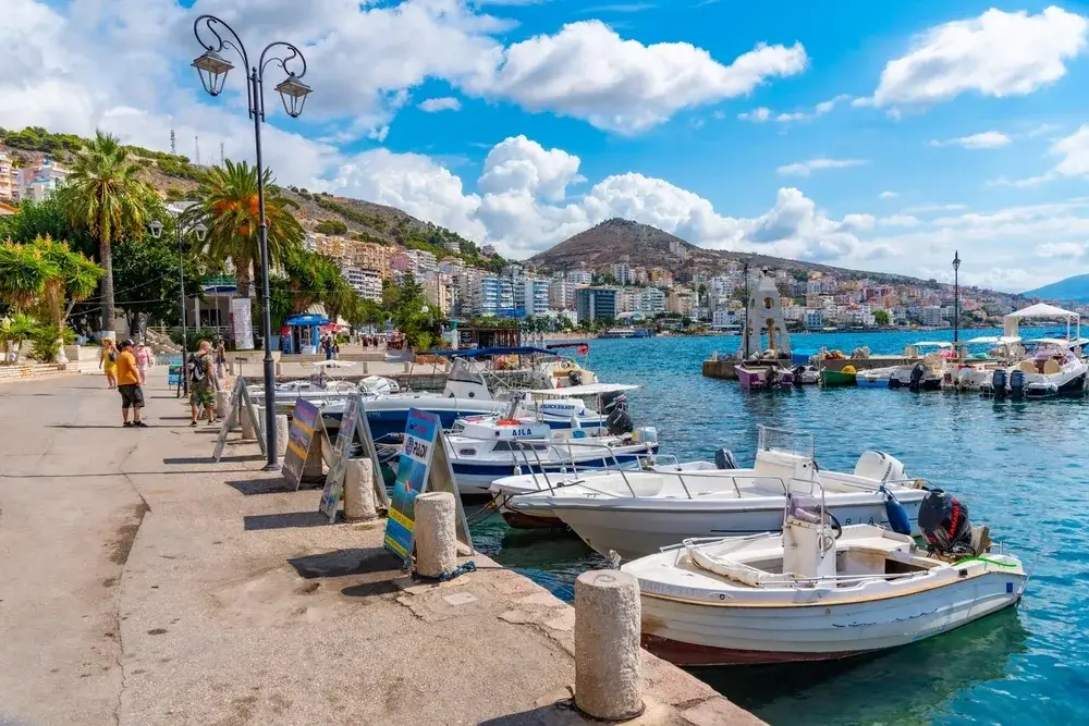 SARANDE, ALBANIA, SEPTEMBER 26, 2019: Boats mooring alongside seaside promenade at Sarande, Albania