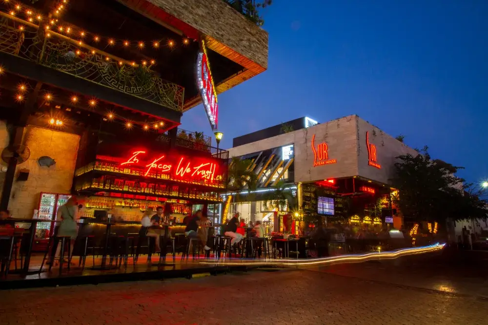 For a piece on Is Playa Del Carmen Safe to Visit, a number of bars and restaurants on a well-lit street