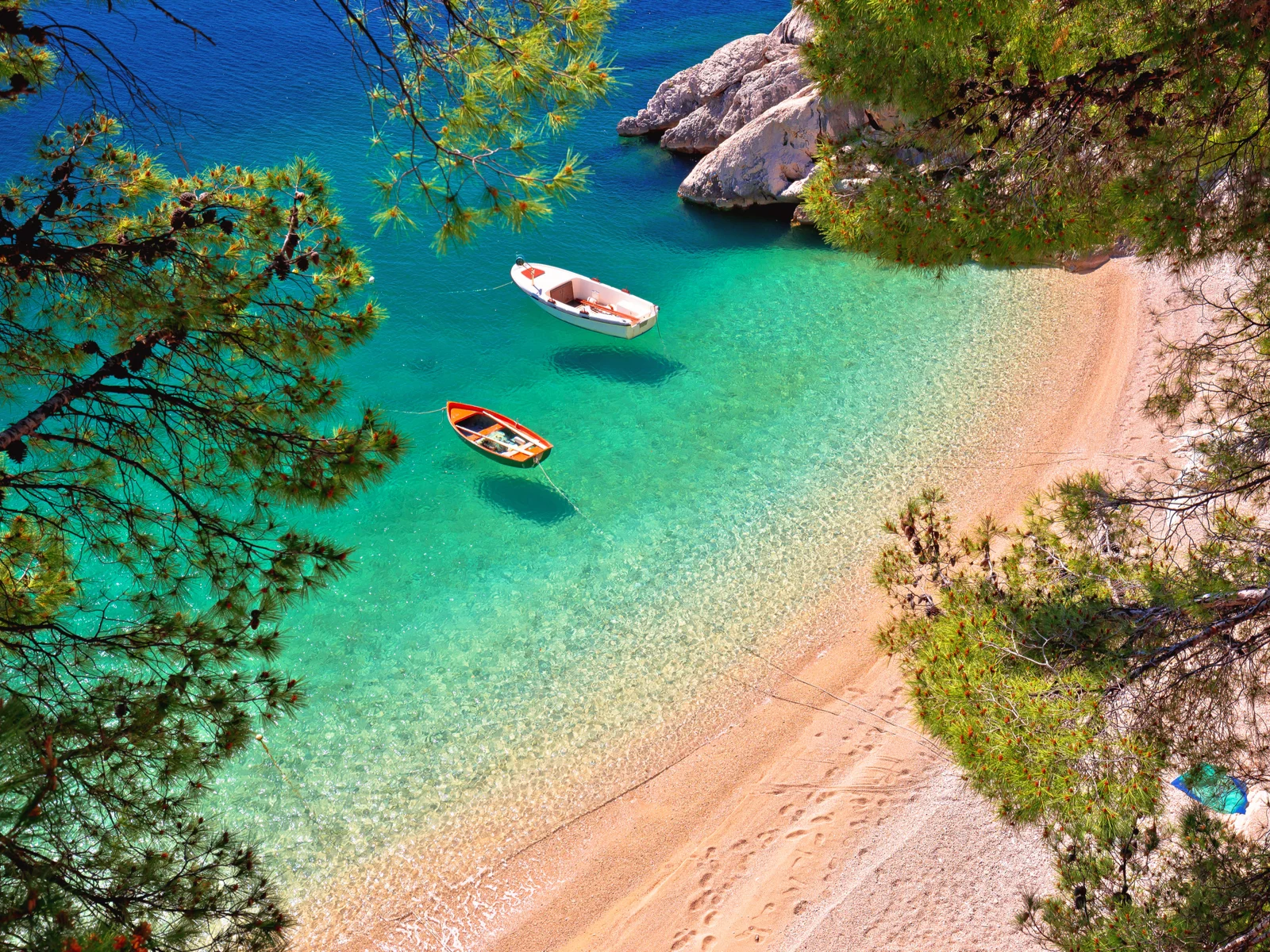 Boats that look like they're floating on water that is clear during the best time to visit Croatia