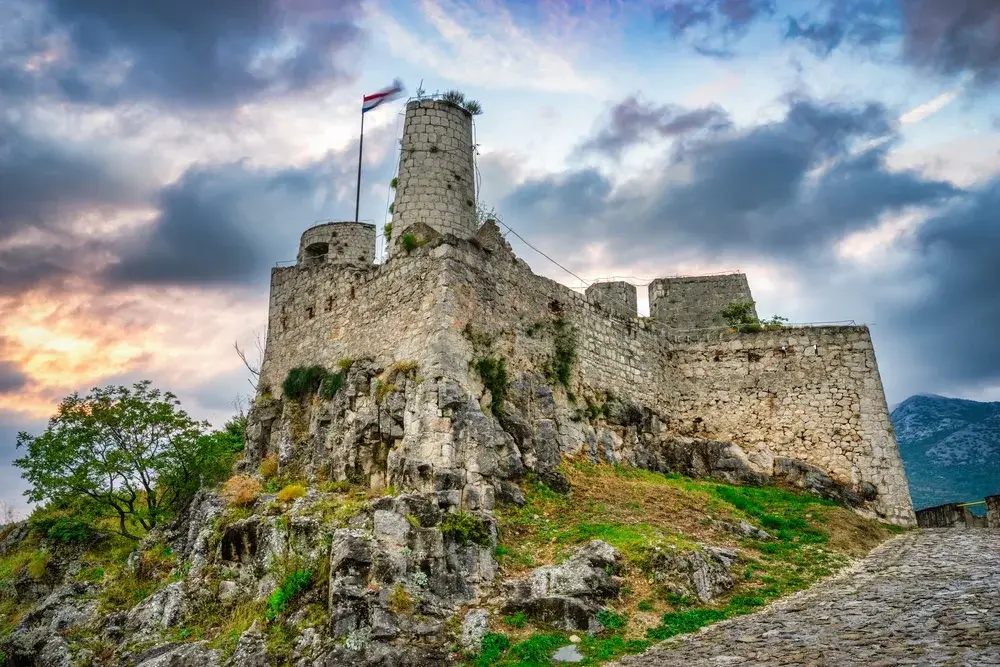 Klis Fortress near Split with cloudy skies overhead for a piece on Is Croatia Safe