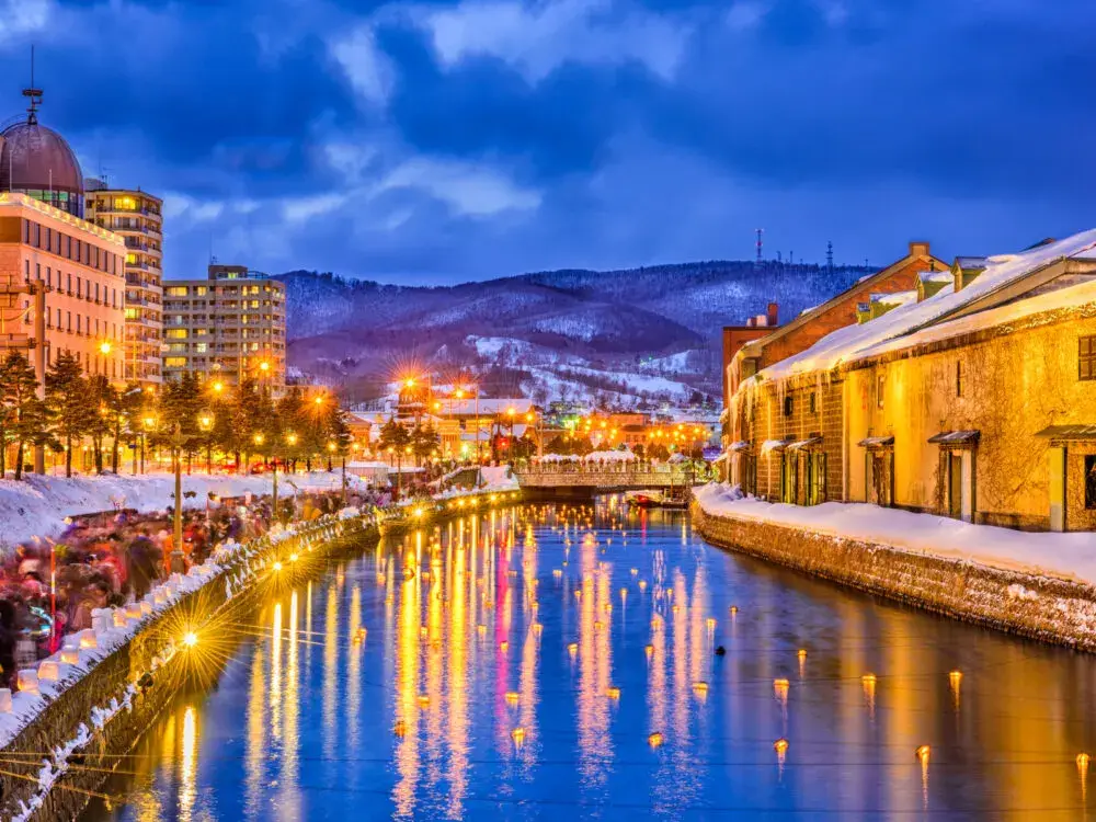 Sapporo Japan canal at night with lights illuminating the water