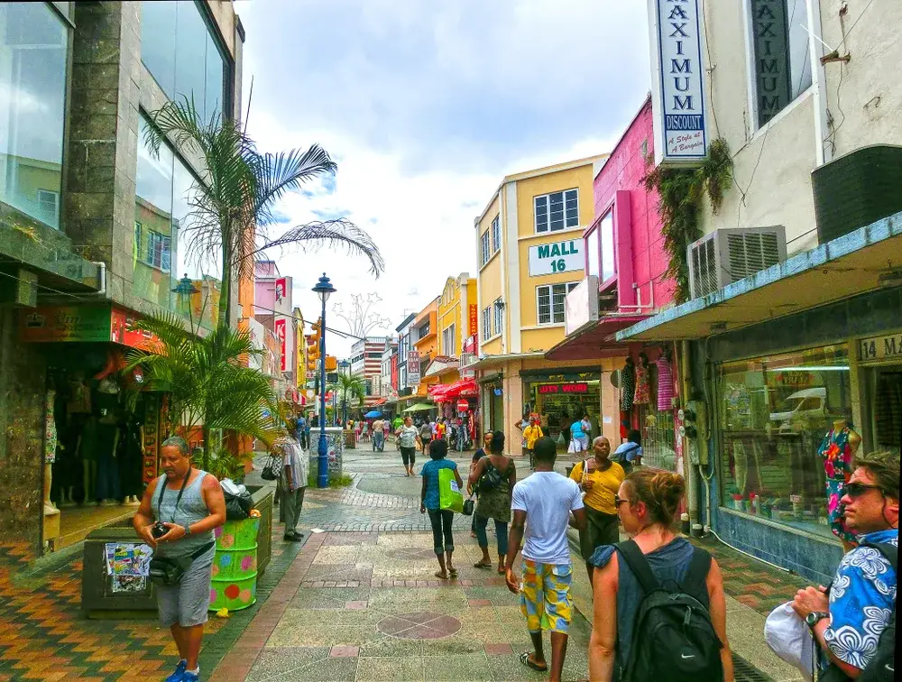 Bridgetown market with people walking along the street during the cheapest time to visit Barbados