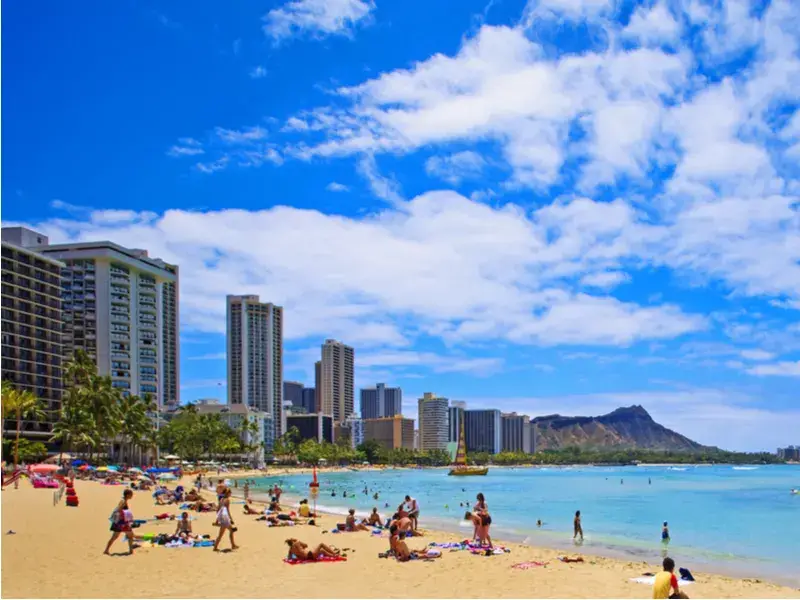 Crowded beach on Waikiki for a piece on the worst time to visit Hawaii