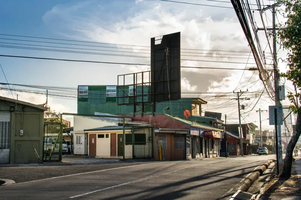 Barrio in San Juan pictured for a guide to whether or not Costa Rica is safe to visit featuring a run-down building