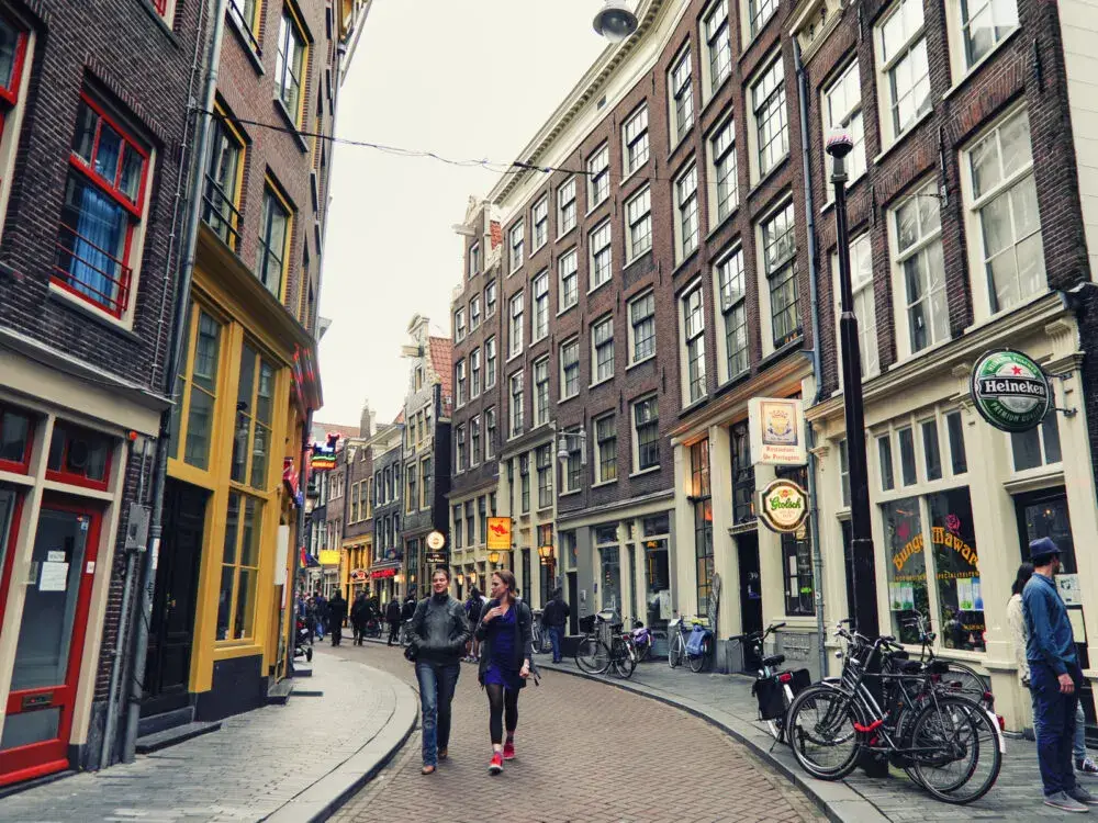 Folks walking down the street during the best time to visit Amsterdam