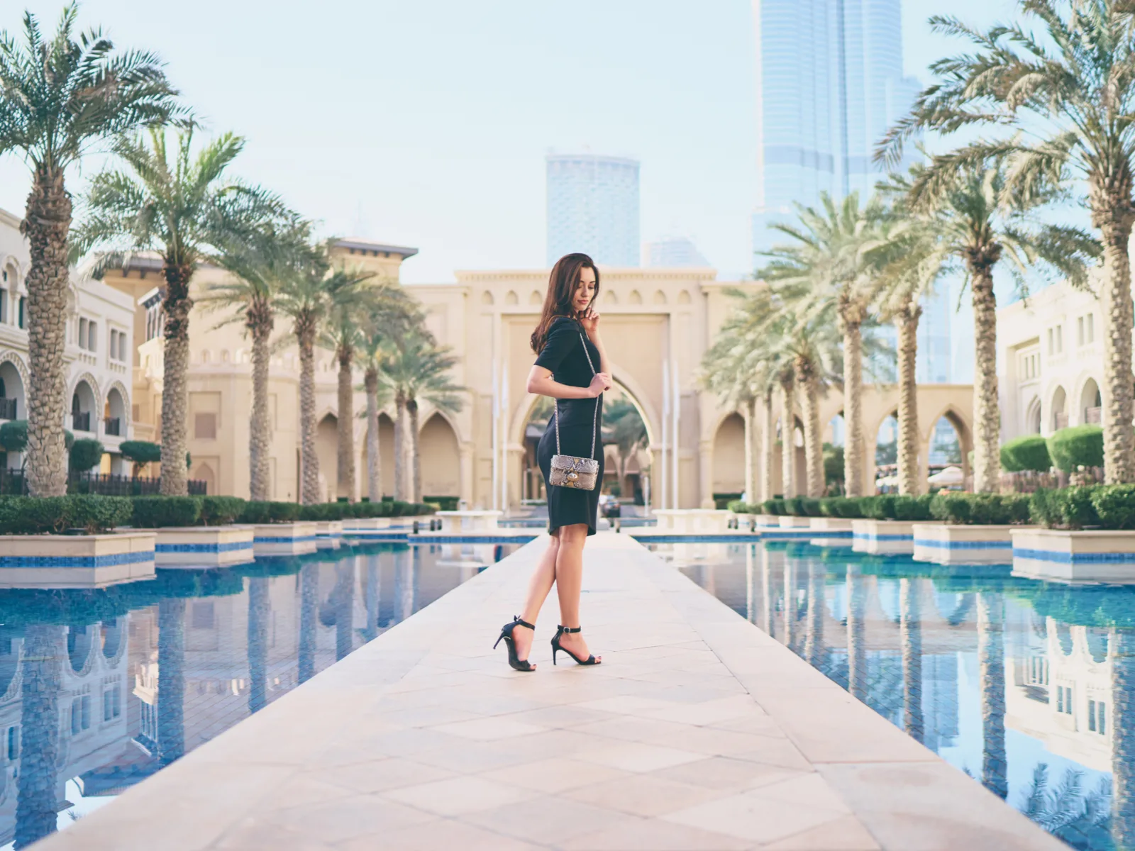 Woman walking on a long walkway during the best time to go to Dubai