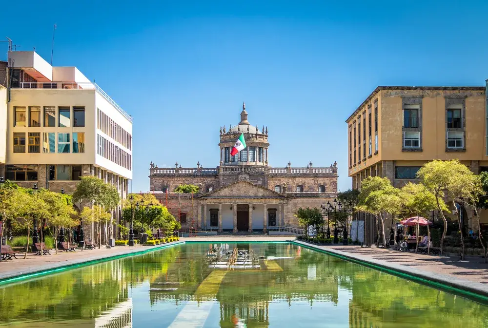 Hospicio Cabanas (the cultural institute) pictured in front of a still pond during the least busy time to visit Guadalajara