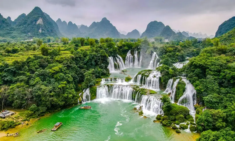 Ban Gioc waterfall with tourists in the water for a piece on Is Cambodia Safe