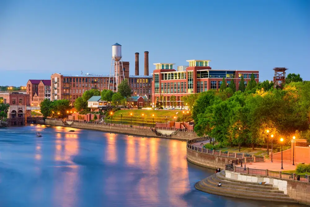 For a roundup of the best places to visit in Georgia, a view of the riverfront promenade and walkway pictured at dusk