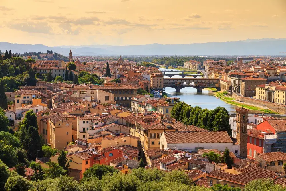 Florence cityscape at dusk with the Ponte Vecchio bridge seen during the best time to visit Florence in early summer