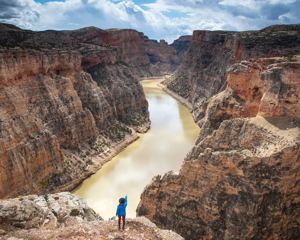 Woman on the edge of a rock face at Bighorn Canyon National Recreation Area in Wyoming