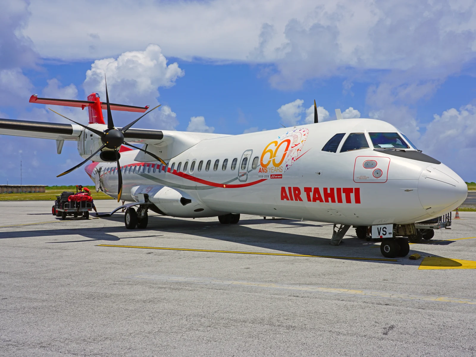 ATR regional airplane on the ramp on a sunny day during the best time to visit Tahiti