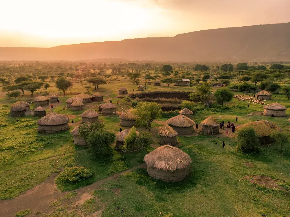 Serial view of mud and stick huts near Arusha during one of the best times to go to Tanzania