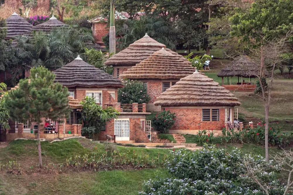 View of round village huts on hill near Victoria Nile River for a piece on Is Uganda Safe