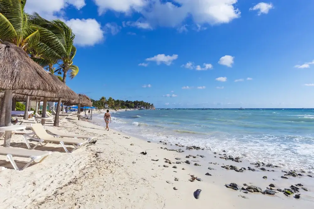 People walking along a beach in Playa del Carmen because it's safe