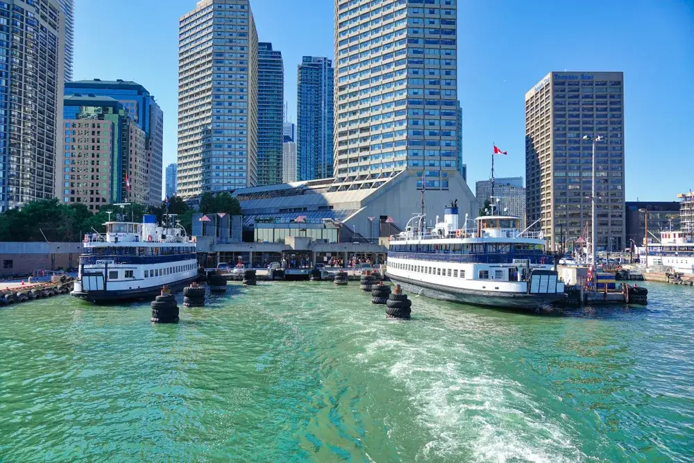 Ferries docked at the port on the water in the downtown area, pictured during the best time to visit Toronto