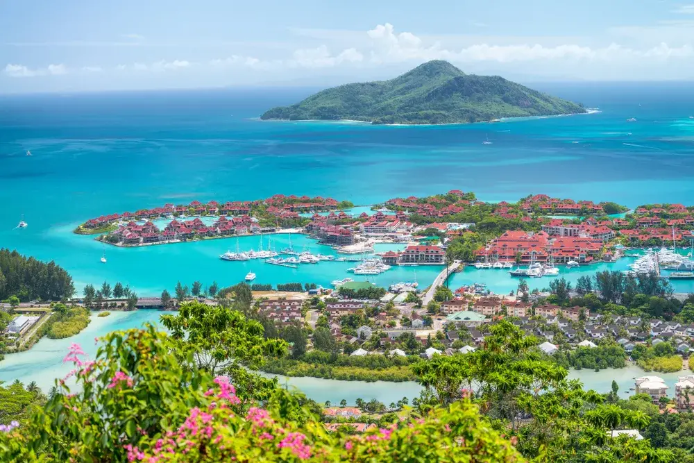 Seychelles, Africa aerial view with red roofs on Eden Island showing the best place for a honeymoon in Africa with mountains in the distance