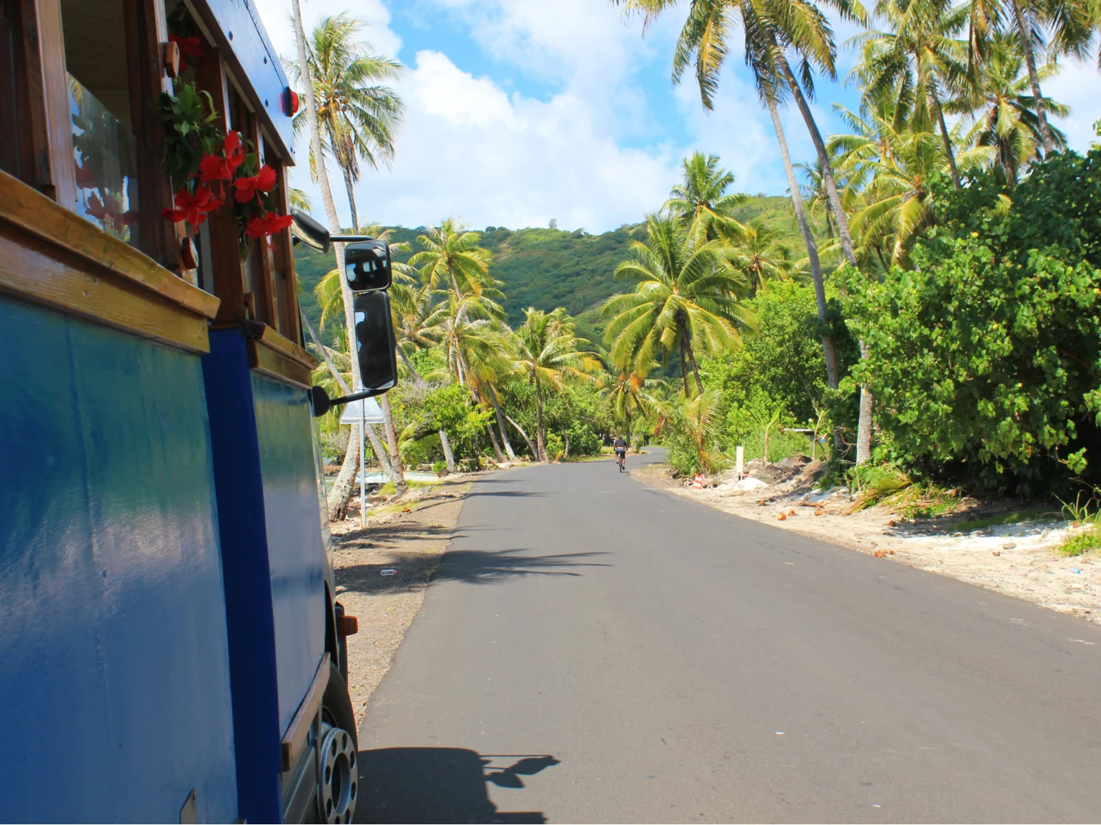 Side view of an open air bus for a frequently asked questions section on the best time to go to Tahiti