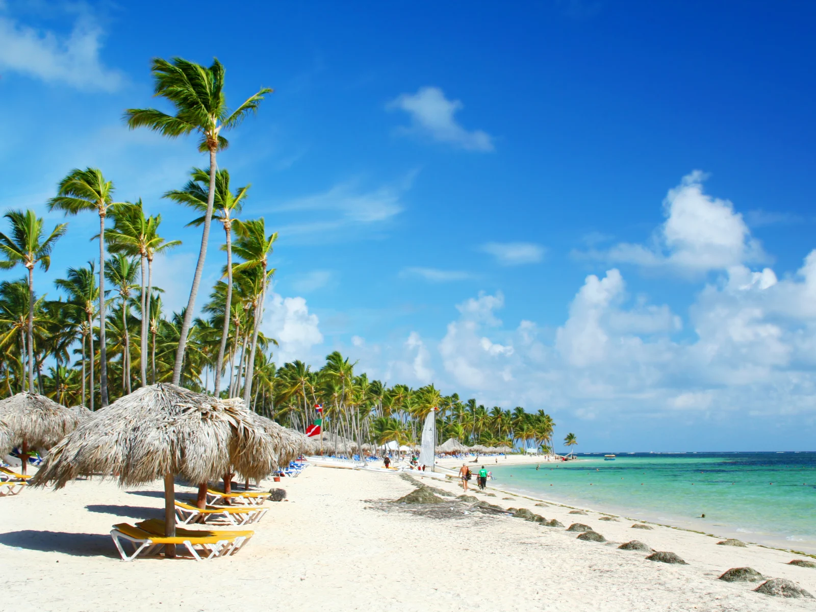 White sand beach (one of Jamaica's best beaches) pictured with white sand and just a few clouds in the sky