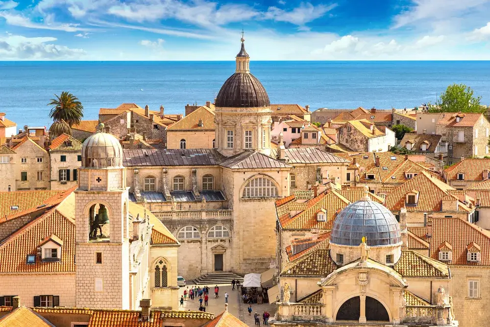 The Old City aerial view with historic buildings and domed roofs seen on a beautiful day during the best time to visit Dubrovnik in the summer