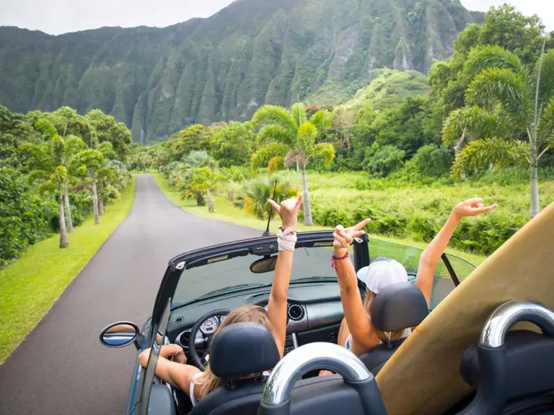 Girls cheering because they booked a trip after learning the best times to visit Hawaii