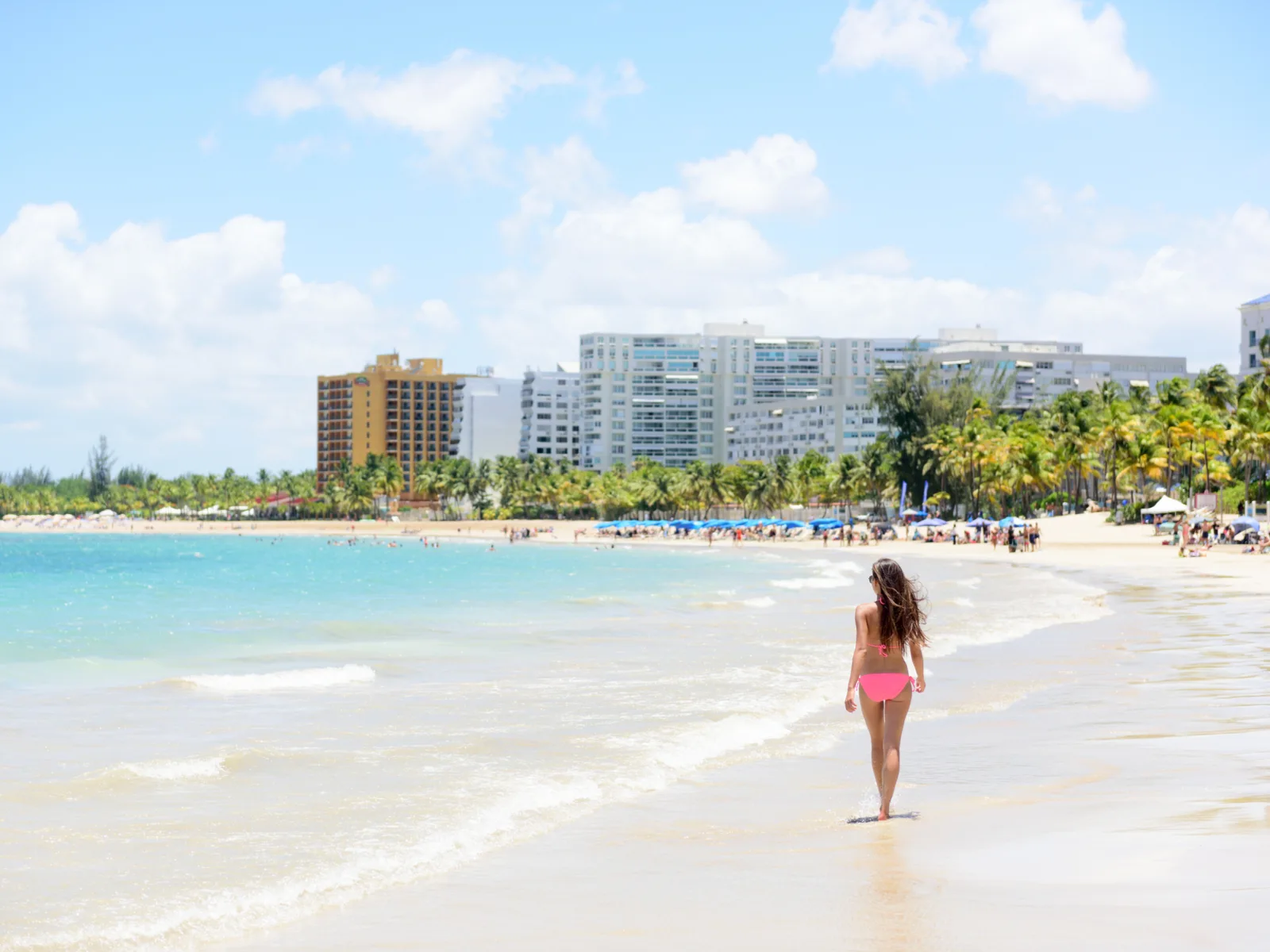 Gorgeous tall woman in a bikini on a beach for a piece titled Is Puerto Rico Safe