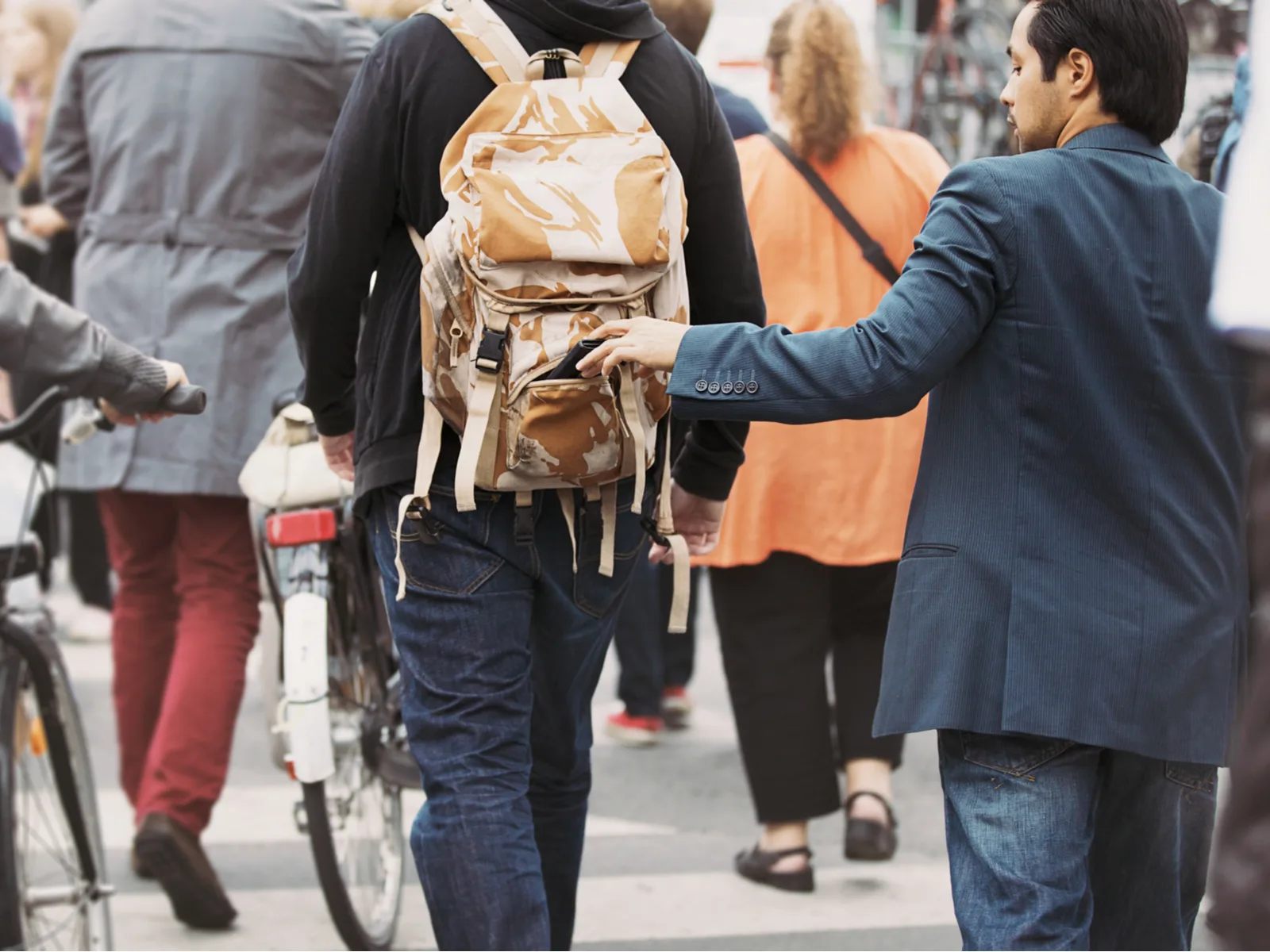 Pickpocket pulling the wallet from a backpack in Chicago for a post on Is Chicago Safe