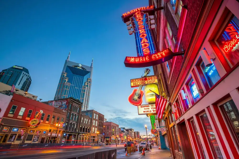 Signs on Lower Broadway at dusk for a piece titled Is Nashville Safe to Visit