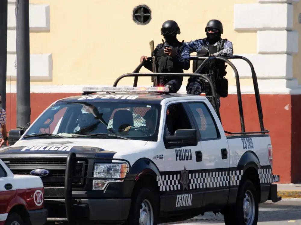 Mexican police in the back of a truck for a piece on Is Tulum Safe to Visit