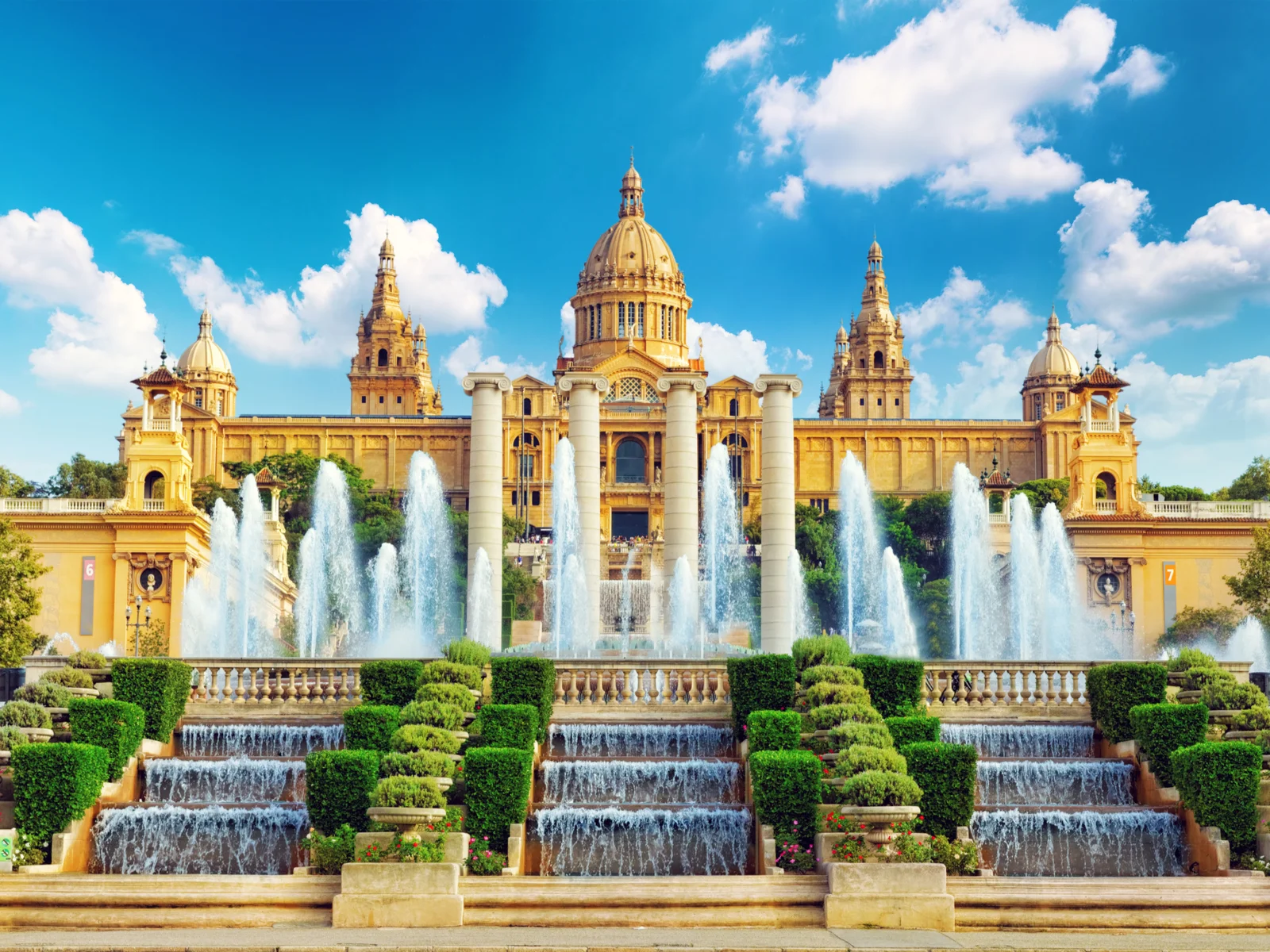 National Museum pictured during the best time to visit Barcelona with blue sky with a few clouds in it