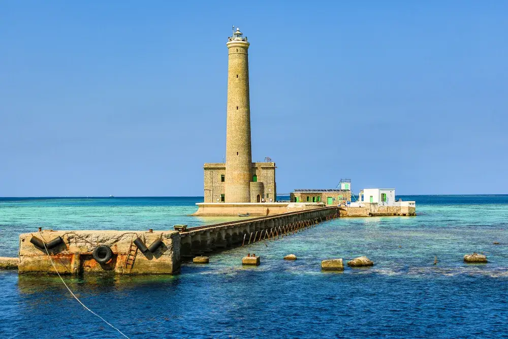 Red Sea coast pictured with a lighthouse in Sanganeb towering over the teal water