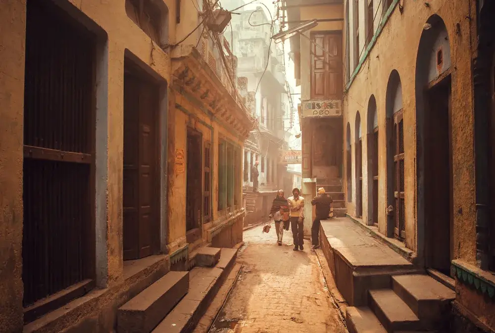 Locals walking down the street in Varanasi during the least busy time to visit India